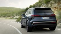 Audi Q7 Generation 3 in Heckansicht auf kurvenreicher Landstraße während der Fahrt.