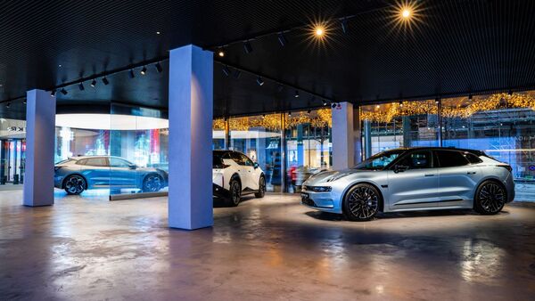 Ausstellungsfläche mit mehreren Zeekr Elektrofahrzeugen im Innenraum eines Showrooms mit großen Glasflächen.