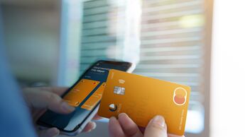 Business woman hand hold credit card to shopping internet online bill on computer, Debit saving purchase buy on table background. Shopaholic people retail pay sale money, bank terminal account concept