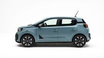 Dacia Spring in hellblauer Lackierung in seitlicher Ansicht mit fünf Türen, schwarzen Karosseriedetails und Leichtmetallrädern.