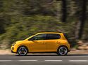 Gelber Renault Twingo E-Tech Electric in Seitenansicht während der Fahrt auf einer Straße.
