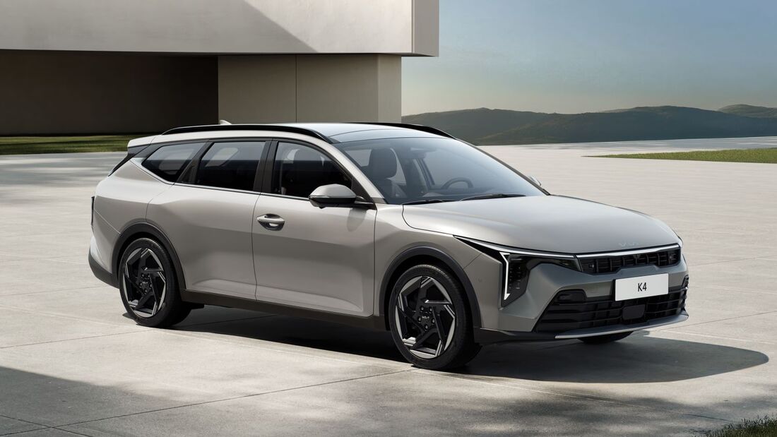 Kia K4 Sportswagon als Kombi in Front-Seitenansicht auf heller Fläche vor moderner Architektur.