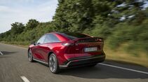 Mazda 6e in roter Lackierung bei Fahrt aus Heckperspektive