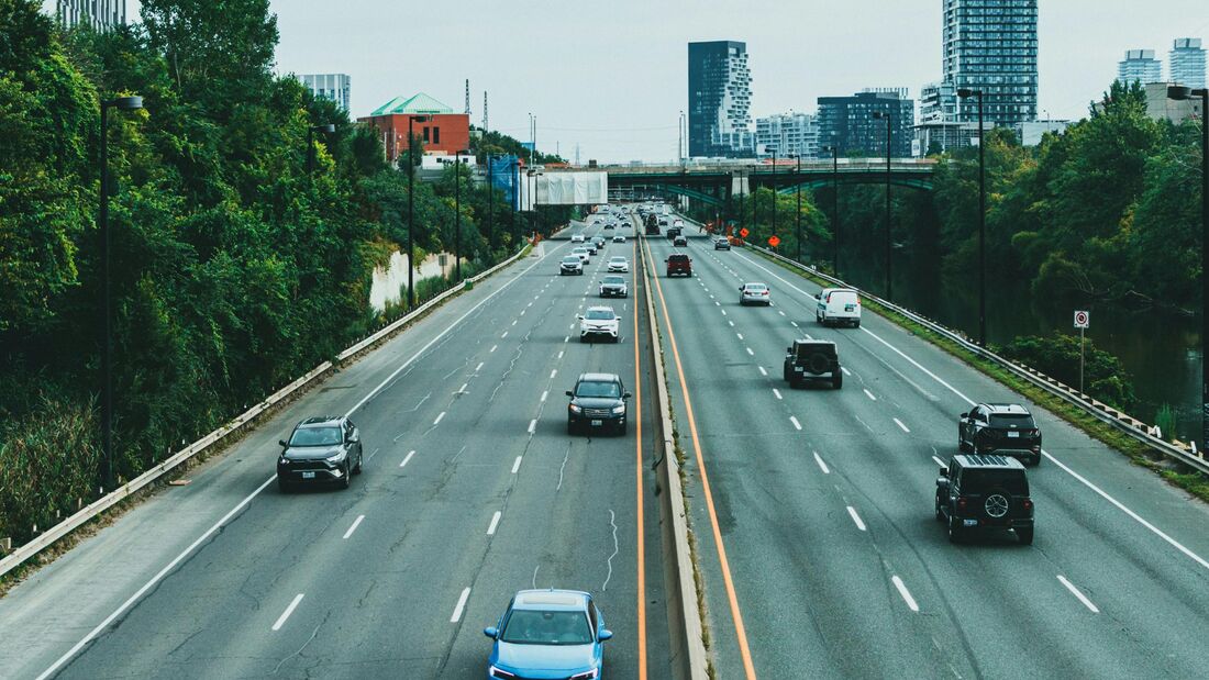 Mehrere Autos fahren auf einer mehrspurigen Stadtautobahn. Beim Nachfahren muss der Abstand für die Geschwindigkeitsmessung stimmen.