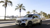 Mercedes GLB fährt auf Straße mit Palmen im Hintergrund