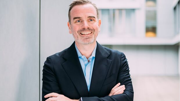 Porträt von Sébastien Valy, Geschäftsführer von Arval Deutschland, im Außenbereich eines Bürogebäudes.